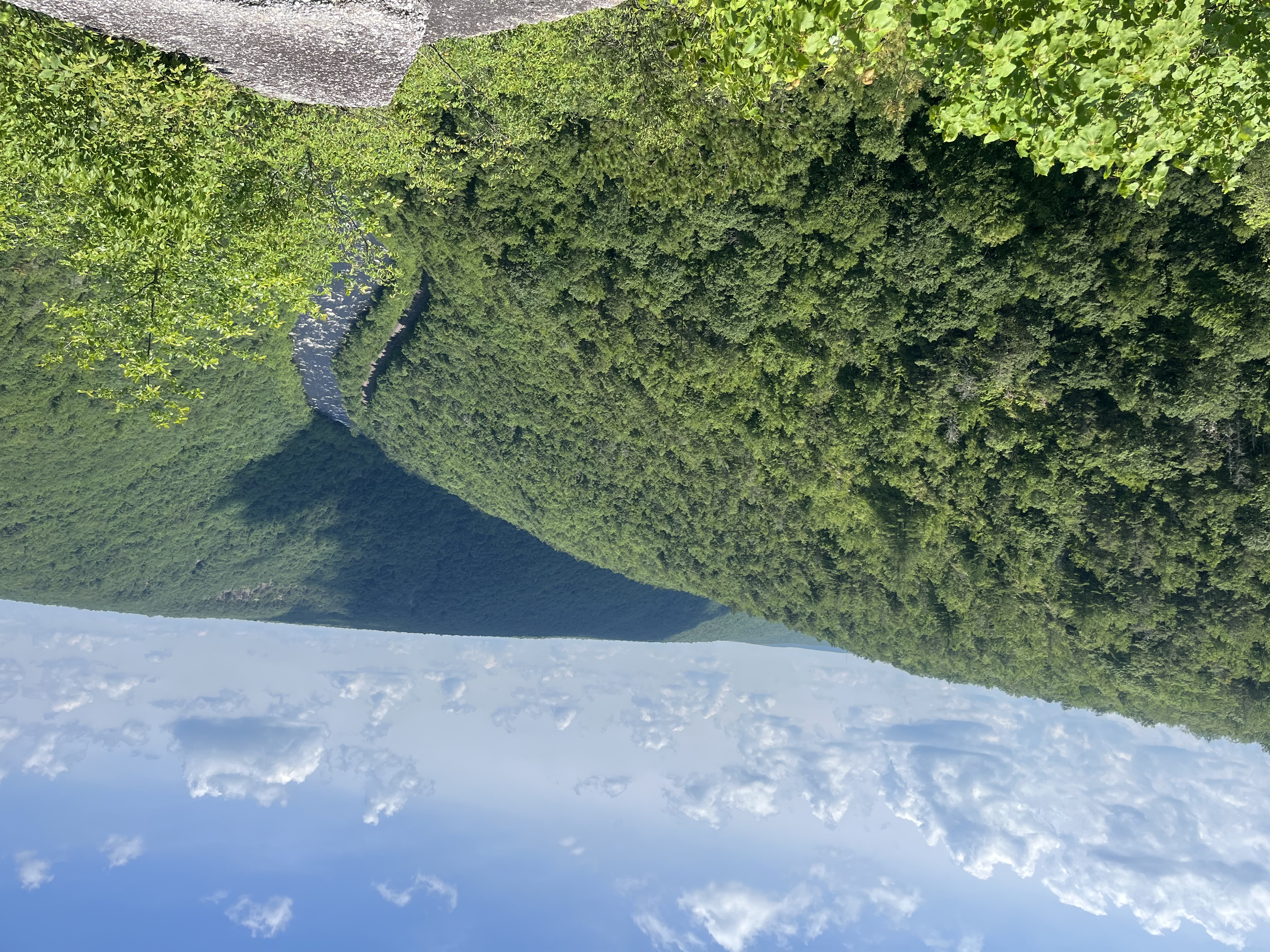 A summit/clifside with the delaware river flowing and winding along the mountains.